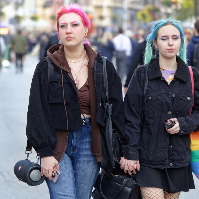 18 - Two individuals walking together in an urban environment